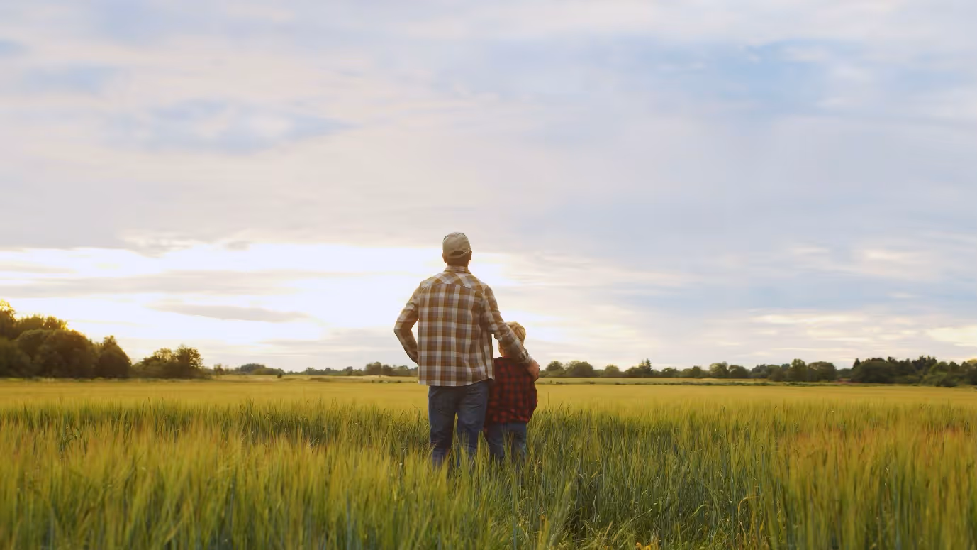 Farmer and son in field
